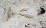 Man bound, face down in thick, kaolin clay