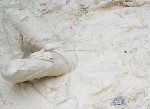 Man struggling in thick, kaolin clay
