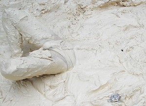 Man struggling in thick, kaolin clay