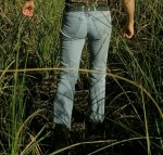 man in tight jeans, walking in the swamp