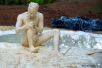 man covered in clay