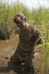 muddy man in swamp
