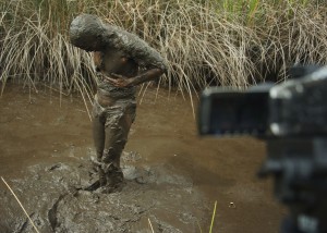 Covered in swamp mud, in front of the video camera