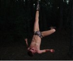 man hanging upside down by ankle